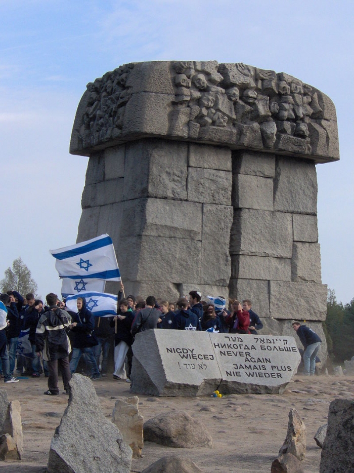 Highschool studants waving israeli flags in Treblinka extermination camp as part of the Holocast remembrance trip to Poland