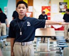 August Say, 12, holds out his arm to determine where he should stand in class in the new Dragon Leadership Corps at his middle school in Bowling Green, Ohio. 